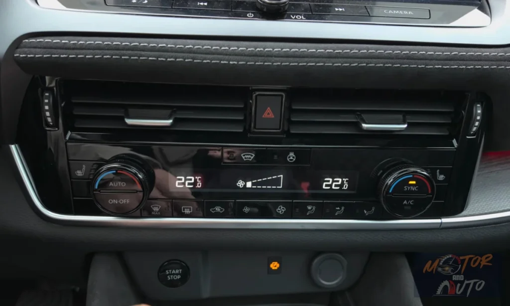 Detailed view of dual-zone climate control panel with digital display and physical rotary temperature controls