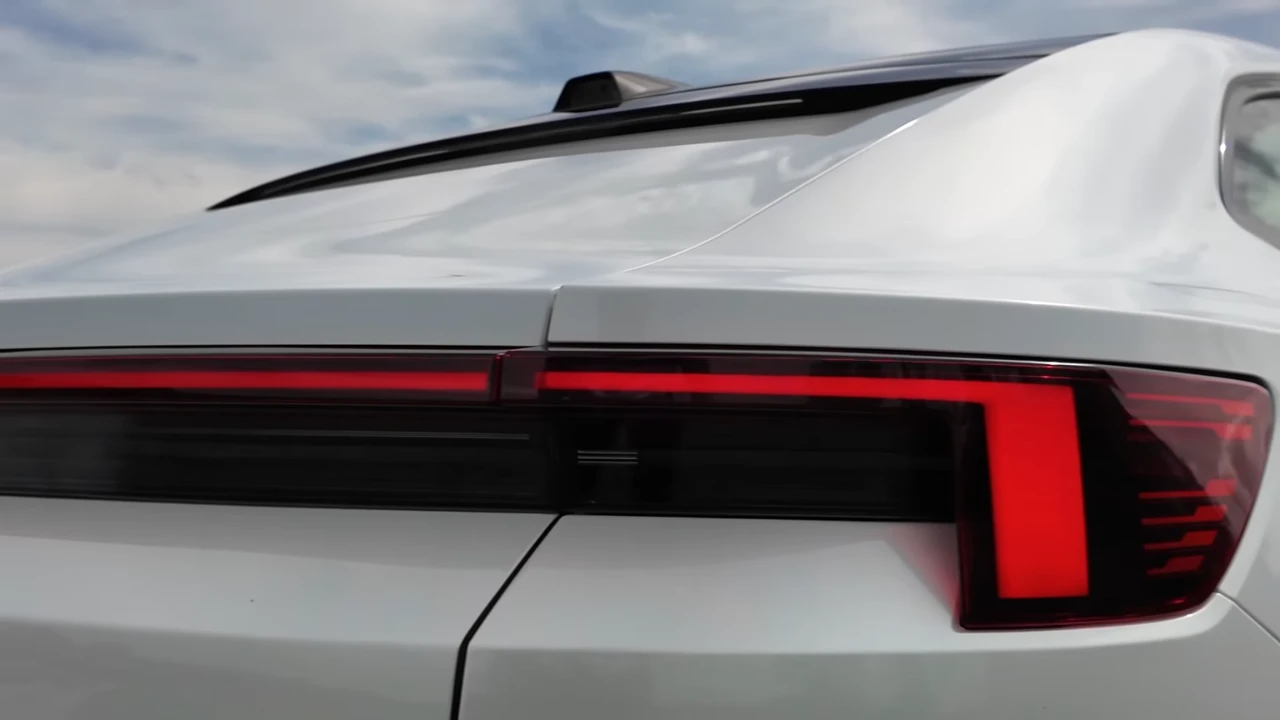Close-up detail van het achter-LED-licht van de 2025 Polestar 4 met rode verlichte secties, modern geometrisch ontwerp en premium zwart-witte afwerking
