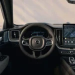 Bestuurdersperspectief van de XC60 cockpit met stuurwiel, meters en centraal display