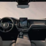 Groothoekweergave van het XC60 interieur met dashboard, stoelen en panoramadak