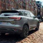 Achter driekwart aanzicht van 2025 Renault Austral op stadsstraat met bijgewerkte achterzijde styling en SUV proporties