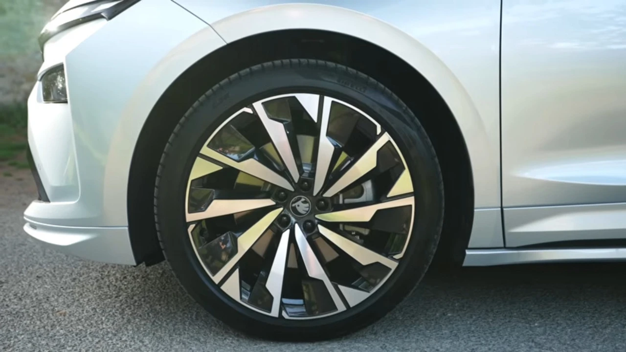 Close-up detail van 2025 Škoda Enyaq 20-inch zwart metallic lichtmetalen velg met multi-spaaks ontwerp en Škoda centrumkap
