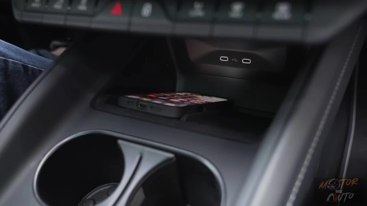 Detailbeeld van 2025 Škoda Enyaq draadloze oplaadzone in middenconsole met smartphone plaatsingszone en dubbele ovale oplaad indicatoren