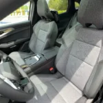 Het interieur van de Renault Austral uit 2025 toont de kenmerkende stoffen bekleding van de Techno-uitvoering