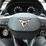 Gedetailleerd zicht van Cupra Leon stuurwiel met logo, bediening en schakelpaddels