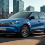 Driekwart vooraanzicht van de 2025 Ford Capri elektrische SUV in blauw gepositioneerd in stedelijke omgeving