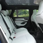 Achterbank-zicht van 2026 Audi A6 met ruime passagiersruimte, lichtgekleurde bekleding, panoramisch schuifdak en comfortabele zitopstelling