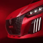 Vooraanzicht detail van 2026 Peugeot e-208 GTi met zwarte honingraat grill met rode GTi badge, LED koplamp cluster, en sportieve voorbumper met luchtinlaten