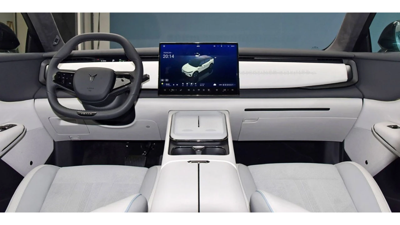 Interieurzicht van Voyah Courage elektrische SUV met wit dashboard, groot OLED-touchscreen, minimalistisch ontwerp, stuurwiel met Voyah-logo en premium cabine-materialen