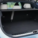 Zeekr 001 met open kofferbak toont 539-liter laadruimte, elektrische achterklep bediening, praktische laadhoogte, en ruime interieur met achterbank zichtbaar