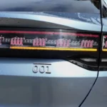 Zeekr 001 achterlicht detail toont LED technologie, doorlopende lichtstrip, richtingaanwijzer elementen, en model badge