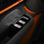 Zeekr 001 Sport Edition interieur deurpaneel met oranje accent verlichting, premium zwarte materialen, speaker roosters, raam bedieningsknoppen en exclusieve oranje ambiënt verlichting details