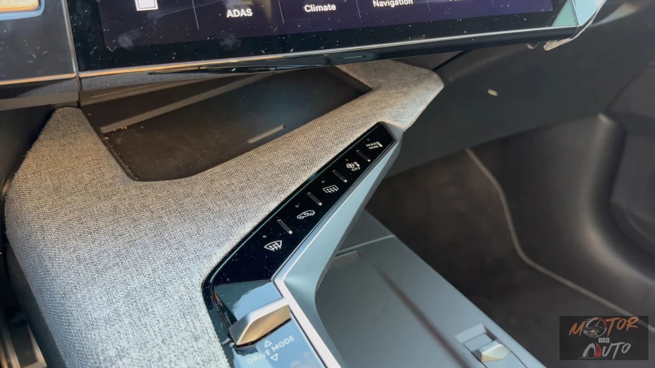 Schuine weergave van de middenconsole van de 2025 Peugeot 5008 met een rij verlichte piano toets-stijl aanraakbediening voor verschillende voertuigfuncties