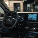 2026 Nissan Micra dashboard met dubbele digitale schermen met navigatie- en instrumentendisplays, Nissan-stuurwiel en modern interieurontwerp