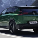 Groene Citroën C5 Aircross plug-in hybrid SUV gefotografeerd vanuit achter driekwart hoek op bergweg, met moderne LED-achterlichten, AIRCROSS-badge en aerodynamische designelementen van het 195pk hybride model