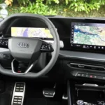 Gedetailleerd zicht van de 2026 Audi Q3 voorcabine met de S-line sportstoelen met microvezelige inzetstukken, afgeplat stuurwiel, gebogen displaypaneel en premium interieurdmaterialen inclusief zacht-touch oppervlakken en sfeerverlichting.