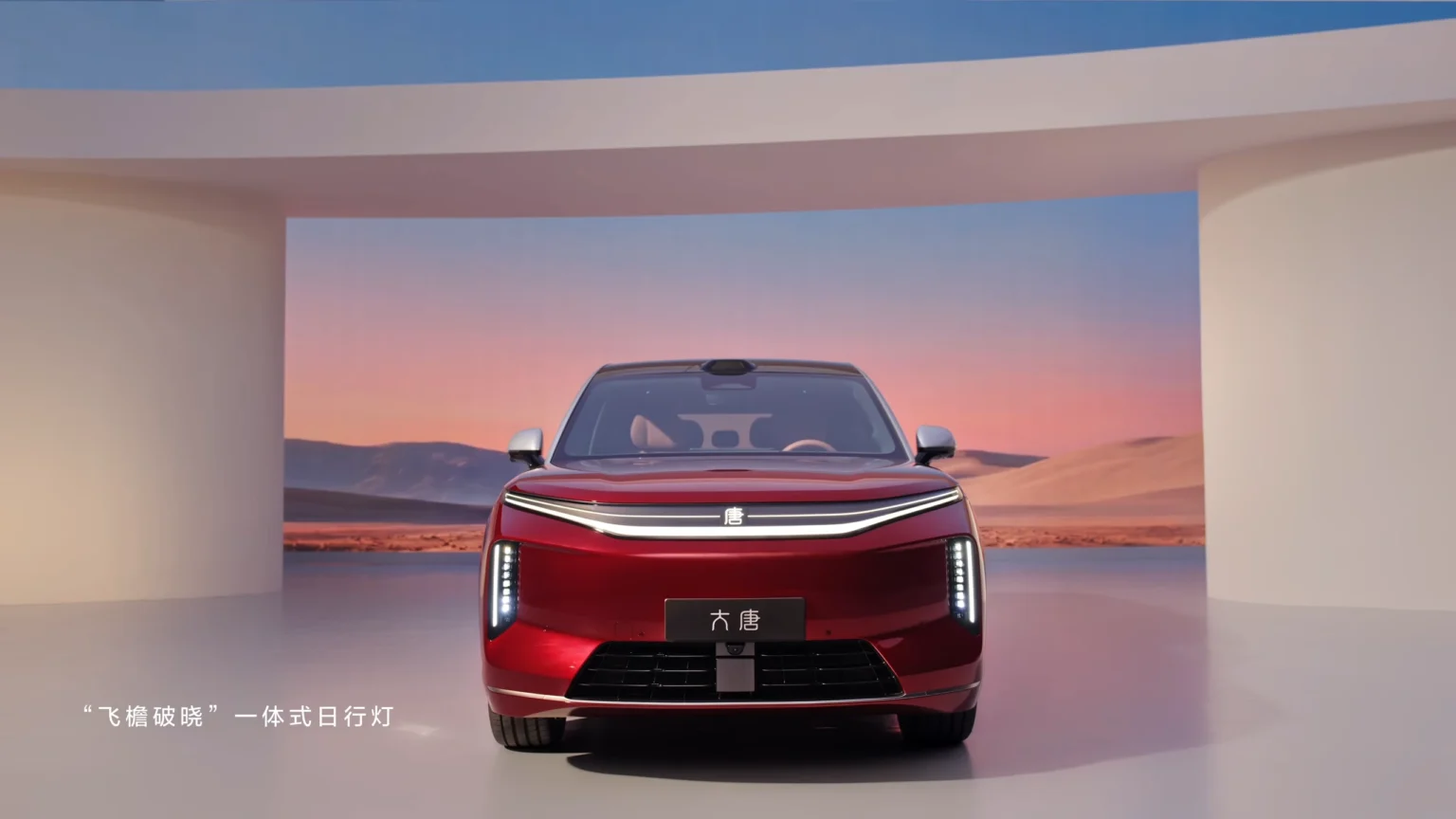 Vooraanzicht van rode BYD Great Tang elektrische SUV met doorlopende LED-lichtbalk en slanke verticale koplampen.